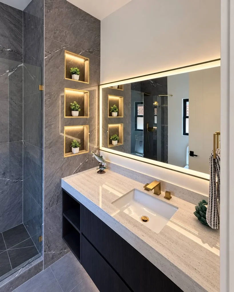 Illuminated mirror and recessed display niches in a bathroom