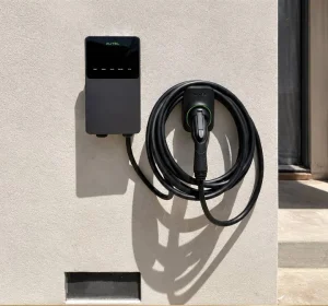 Wall-mounted EV charger with organized cable storage